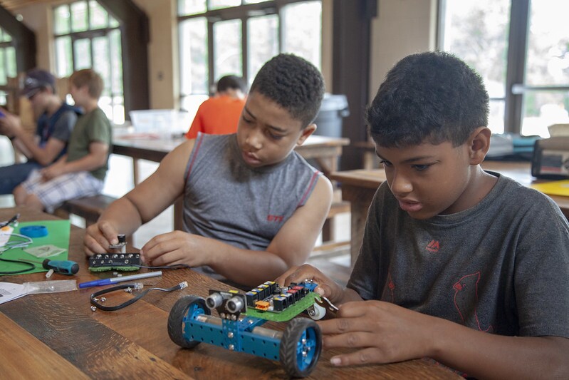 Boys working on robot cars