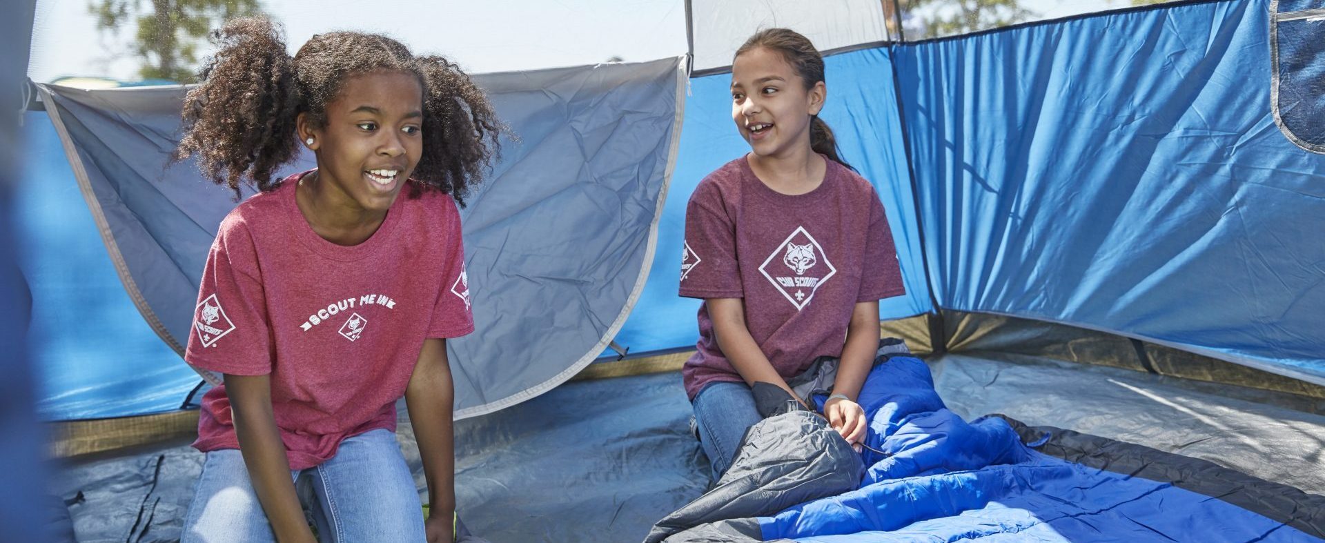 Cub Scouts Camping setting up tent unrolling sleeping bags