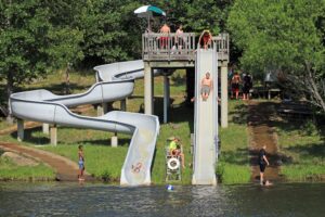Families enjoying water slides at camp