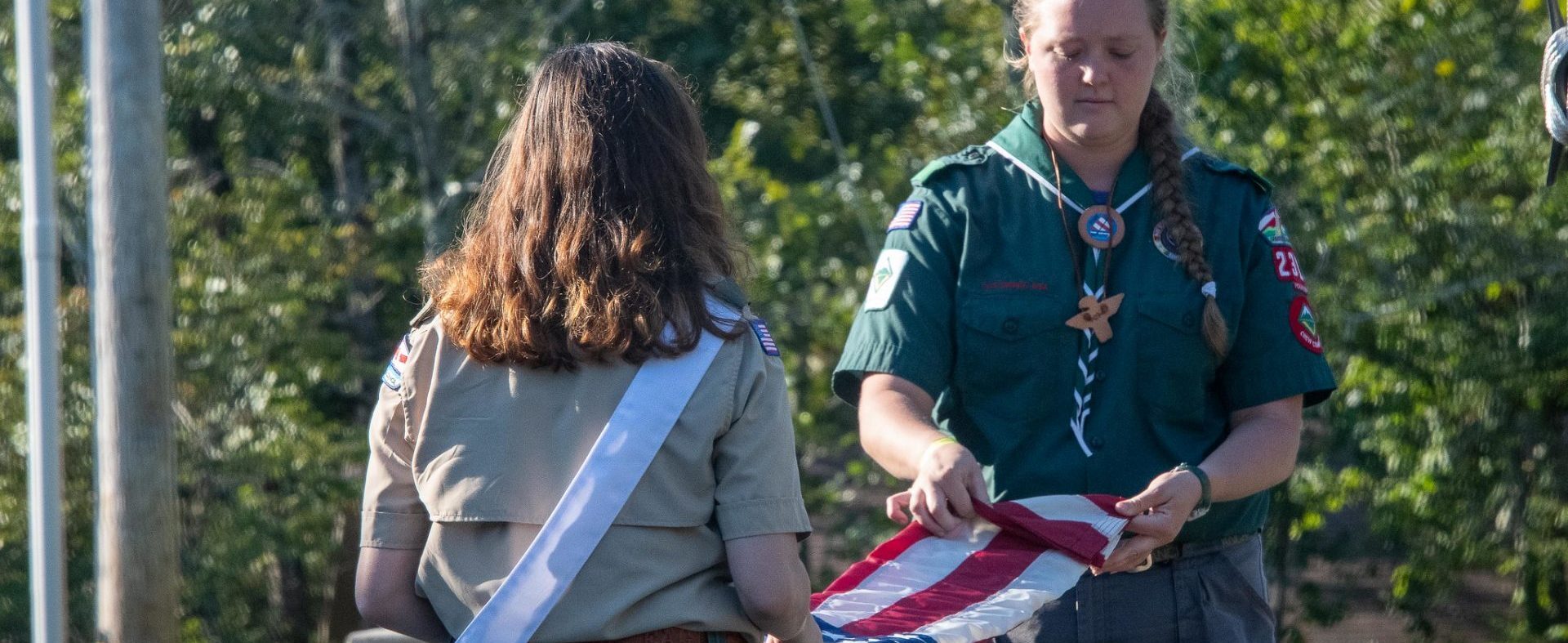Venturing scouts folding the flag